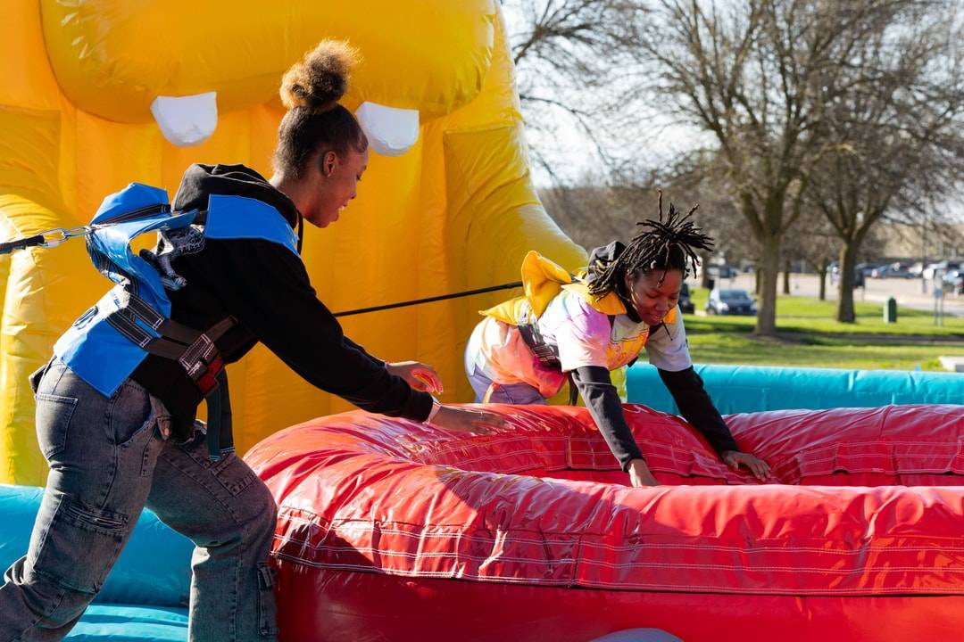 Students playing on an inflatable attraction